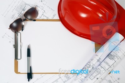 Red Hard Hat And Blueprints Stock Photo