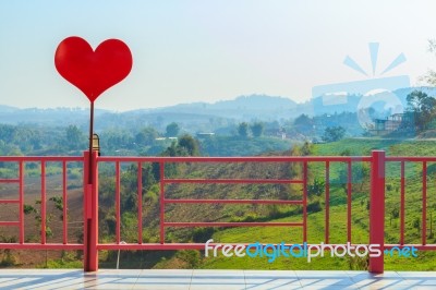 Red Heart And Pink Fence Stock Photo