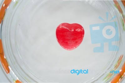 Red Heart Candy On The Glass Stock Photo