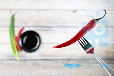 Red Hot Chili Pepper With Water Drops On Fork Stock Photo