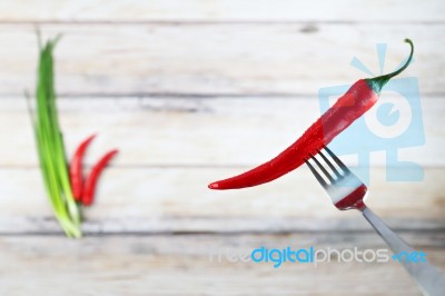 Red Hot Chili Pepper With Water Drops On Fork Stock Photo