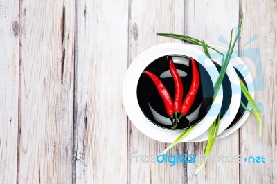 Red Hot Chilli Pepper And Green Onion On Plate Stock Photo