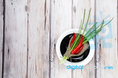 Red Hot Chilli Pepper And Scallions On Plate Stock Photo