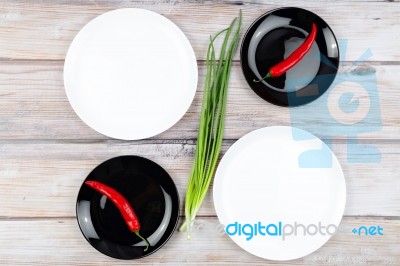 Red Hot Chilli Pepper And Scallions On Plate Stock Photo