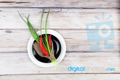 Red Hot Chilli Pepper And Scallions On Plate Stock Photo