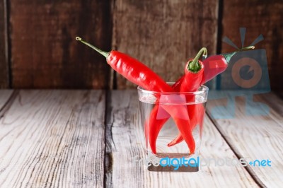 Red Hot Chilli Peppers In Glass Of Water Stock Photo