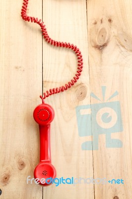 Red Landline Earphone And Cable On Wood Background Stock Photo