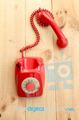 Red Landline Earphone And Cable On Wood Background Stock Photo