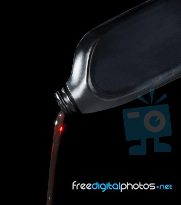 Red Motor Oil Lube Pouring From Black Plastic Bottle Stock Photo