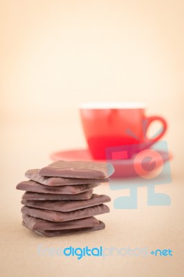 Red Mug Of Hot Coffee And Chocolate Pieces Stock Photo