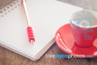 Red Mug With Open Notebook Stock Photo