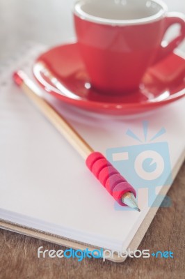 Red Mug With Open Notebook Stock Photo