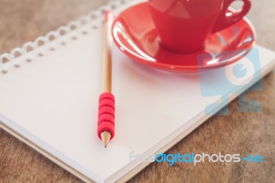 Red Mug With Open Notebook Stock Photo