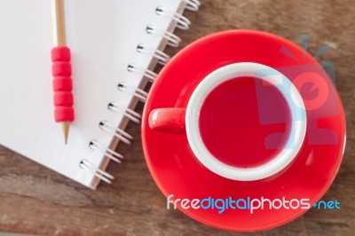 Red Mug With Open Notebook Stock Photo