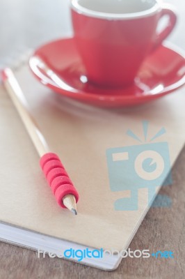 Red Mug With Open Notebook Stock Photo