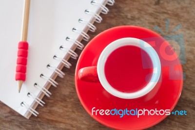 Red Mug With Open Notebook Stock Photo