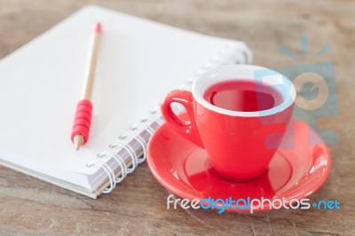 Red Mug With Open Notebook Stock Photo