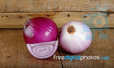 Red Onion On The Wooden Background Stock Photo