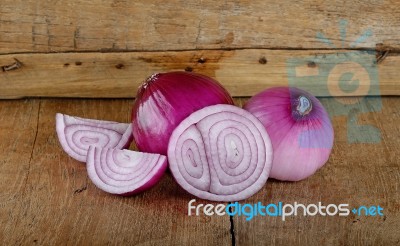 Red Onion On The Wooden Background Stock Photo