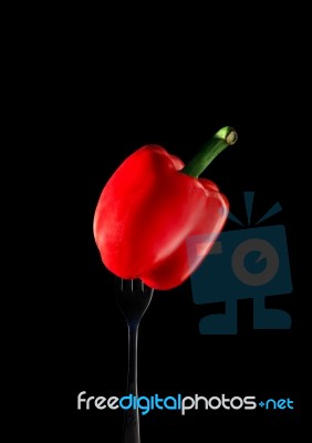 Red Paprika Chilli On Silver Fork With Black Background Stock Photo