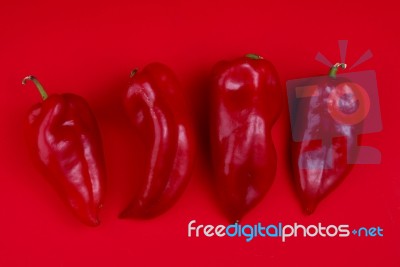 Red Peppers On Red Background Stock Photo