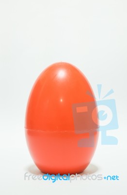 Red Plastic Egg On White Table Stock Photo