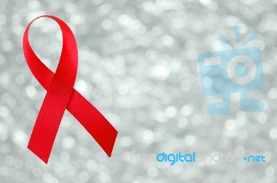 Red Ribbon Sign On Silver Bokeh Background Stock Photo