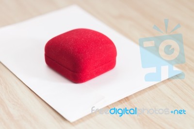 Red Ring Box On Wooden Background Stock Photo