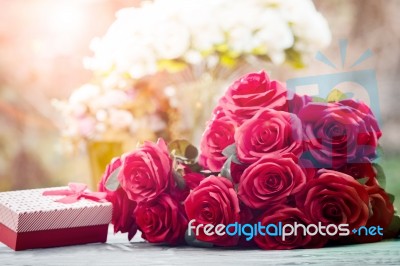 Red Roses Flowers With Valentine Festival Gift And Beautiful Blur Bouquet Background Stock Photo