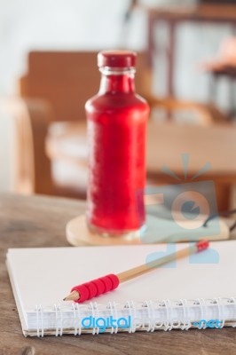 Red Syrup In The Bottle On Wooden Plate Stock Photo