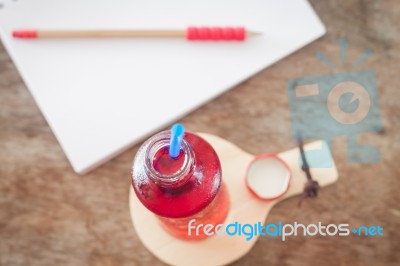 Red Syrup In The Bottle On Wooden Plate Stock Photo