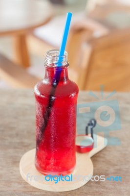 Red Syrup In The Bottle On Wooden Plate Stock Photo