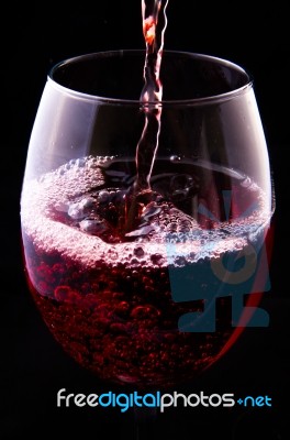 Red Vine Pouring Into A Glass Stock Photo