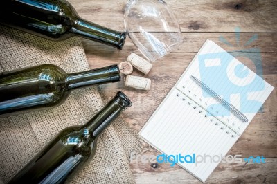 Red Wine Bottle, Glass And Grape Shaped Corks And Open Book Stock Photo