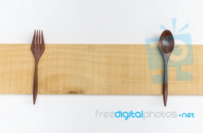 Red Wood Fork And Spoon On Wood Plate Stock Photo