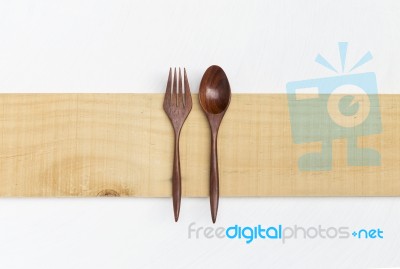 Red Wood Fork And Spoon On Wooden Plate Stock Photo