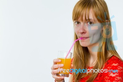 Redhead Girl Drinking Orange Juice Stock Photo