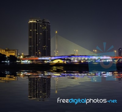 Reflection Of The Beauty Of The Chao Phraya River And Boat At Night With Rationalism At Pinklao Bridge ,bangkok Thailand Stock Photo