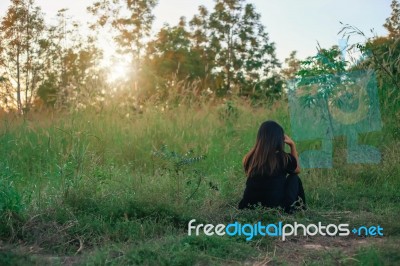 Relax Woman And Sunset Silhouette Stock Photo