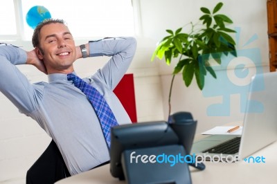 Relaxed Entrepreneur In Office Stock Photo