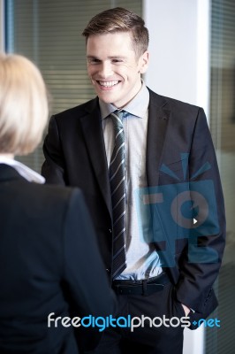 Relaxed Managers Communicating Cheerfully Stock Photo