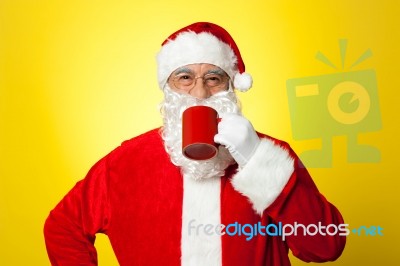 Relaxed Santa Enjoying His Cup Of Coffee Stock Photo