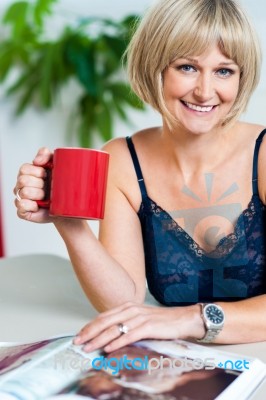 Relaxed Woman In Lingerie Enjoying Her Beverage Stock Photo