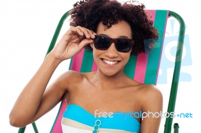 Relaxing Female Model Adjusting Her Shades Stock Photo