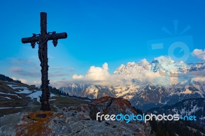 Religious Cross On A Rock With A View Of Mountains Stock Photo