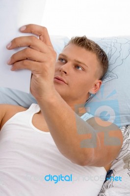 Resting Man Reading Report Stock Photo