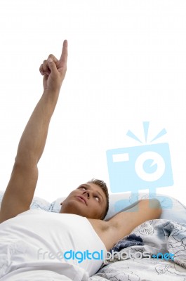 Resting Young Man Pointing Upward Stock Photo