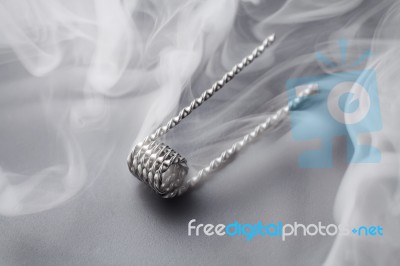 Ribbon Twist Coil For Vaping On A Black Background Smoke Stock Photo