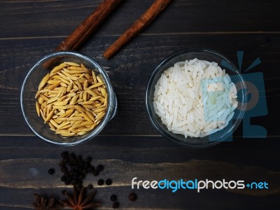 Rice And Paddy In Separated Glasses Stock Photo