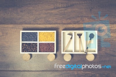 Rice Box And Garden Tools Box On Wooden Cylinder Stock Photo